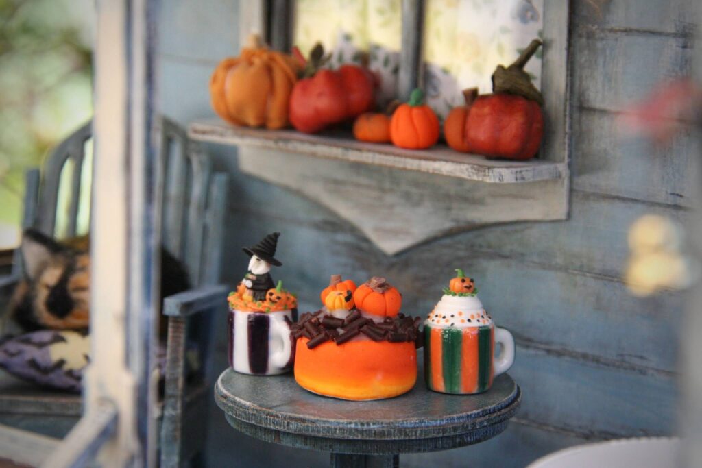 delicious Halloween cake in a table and window is cover of pumpkin 